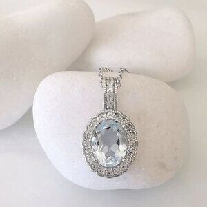 Diamond halo around Sky Blue Topaz pendant necklace